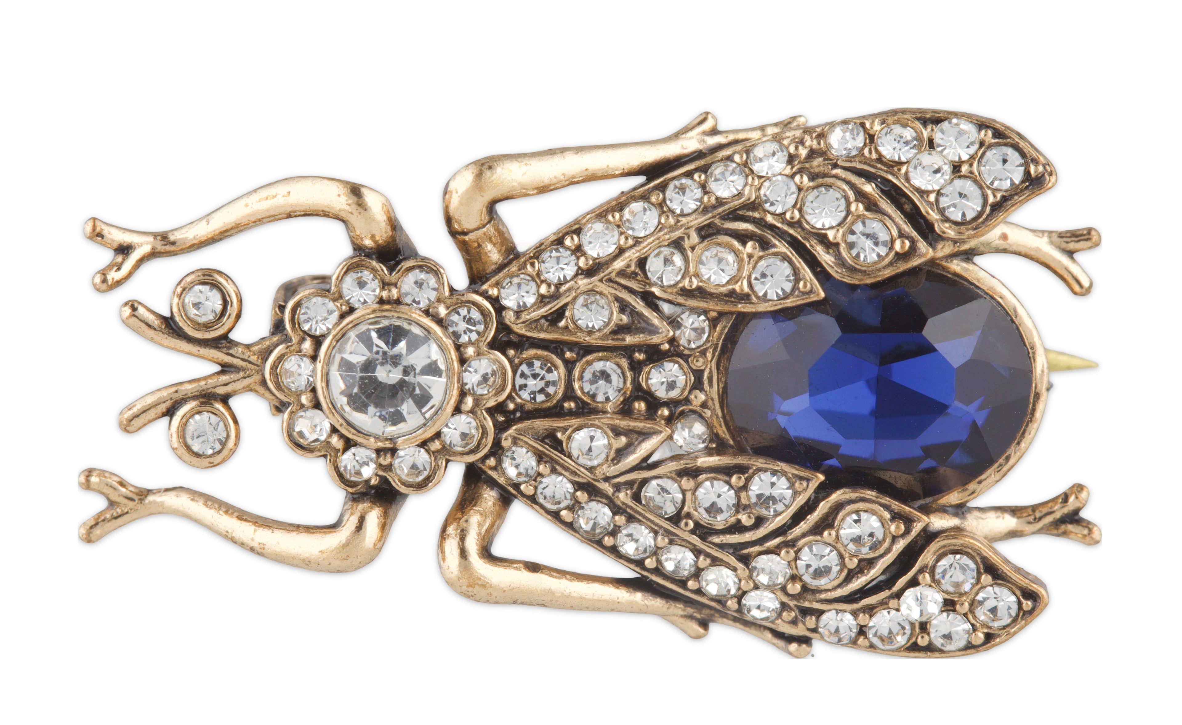 Gold insect-shaped brooch with blue gem and clear stones on a white background