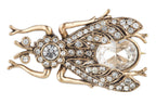 Decorative frog brooch with rhinestones on a white background