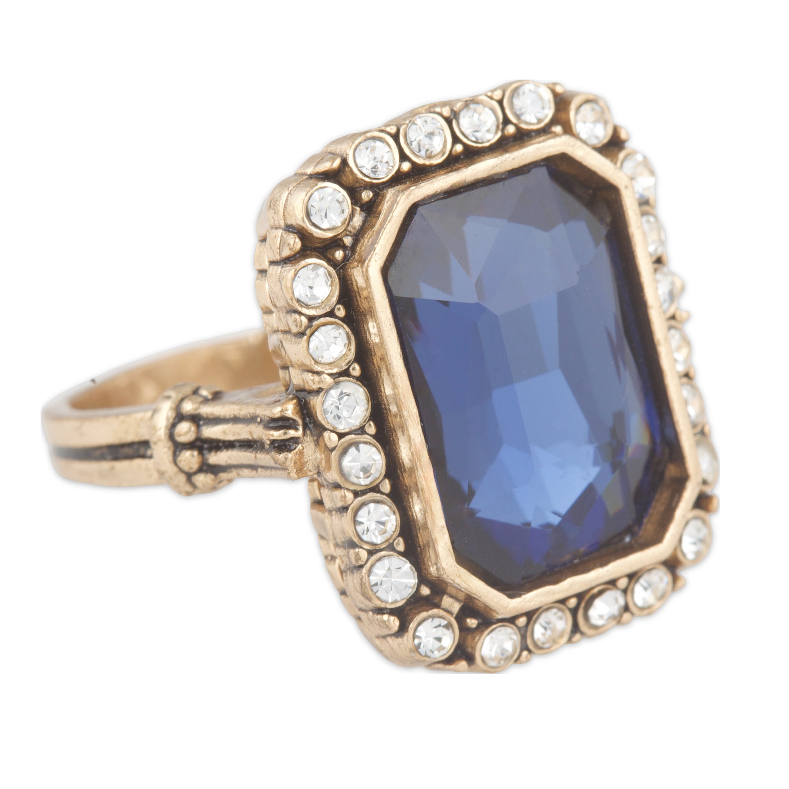 Ring with blue gemstone and gold accents on a white background