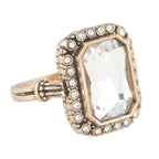 Gold ring with a large central gemstone and smaller stones on a white background