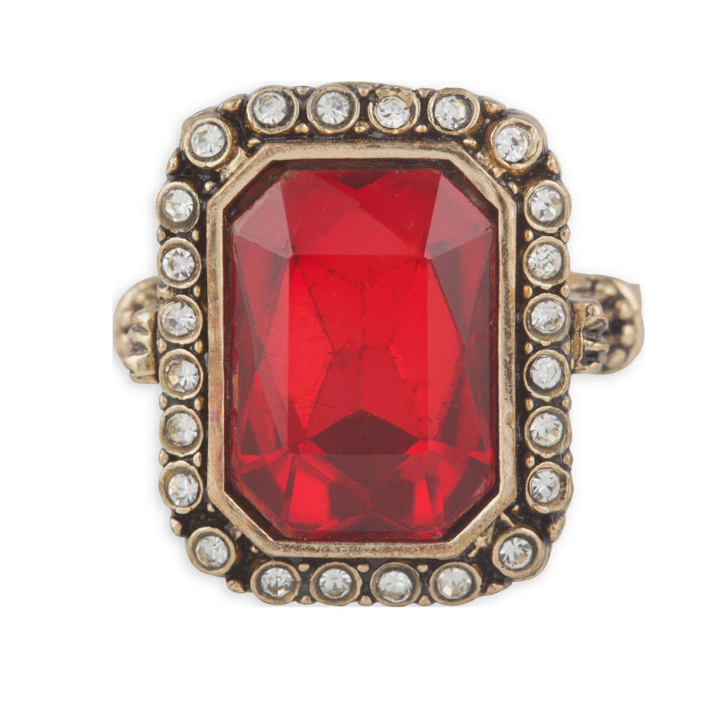Ring with a red gemstone and gold border on a white background
