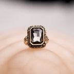 Gold ring with a large gemstone on a soft background