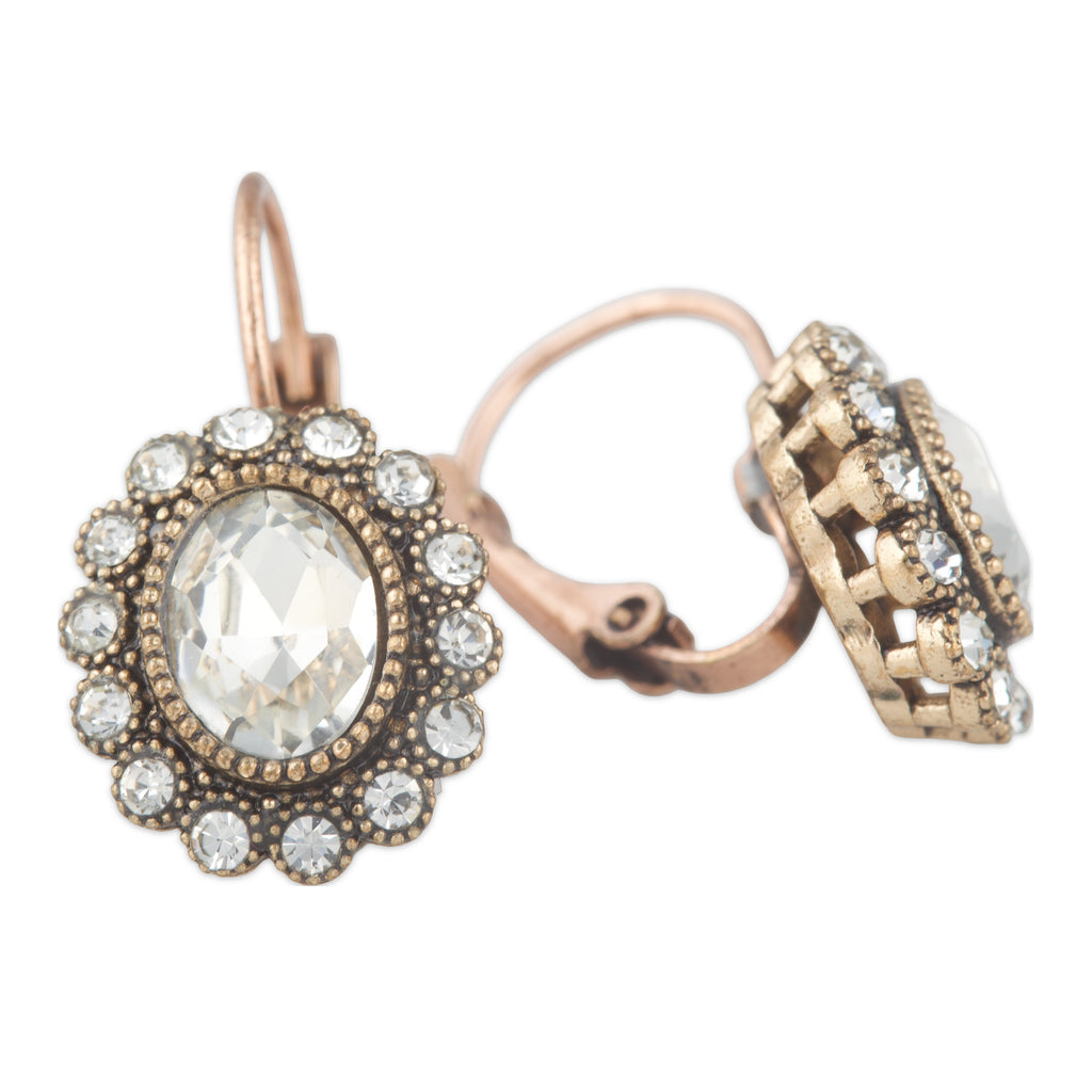 Pair of ornate earrings with intricate designs on a white background