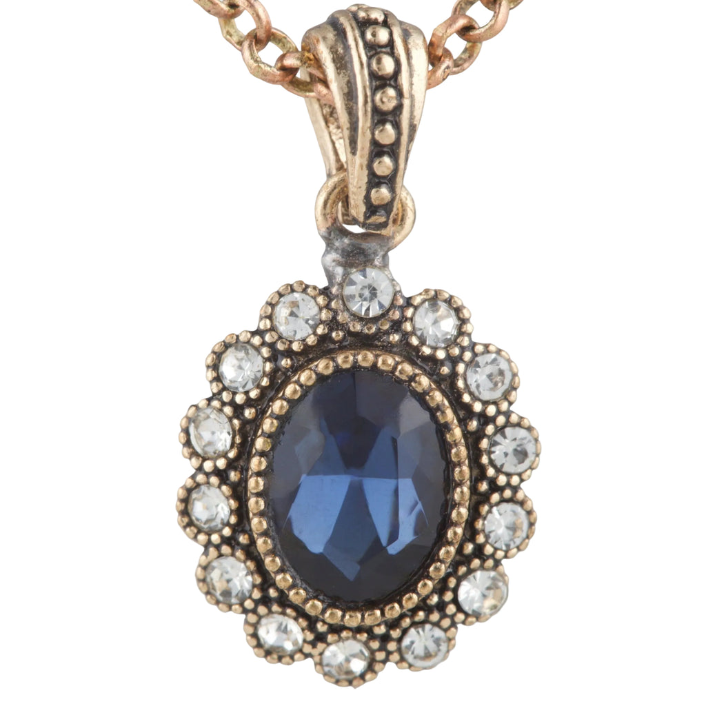 Rose gold necklace with a blue gemstone pendant on a white background