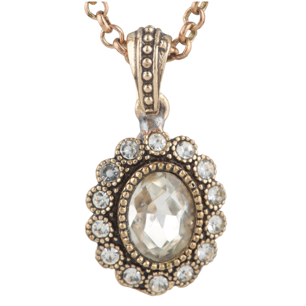 Rose gold necklace with a pendant featuring a large central gemstone and smaller stones around it on a white background.