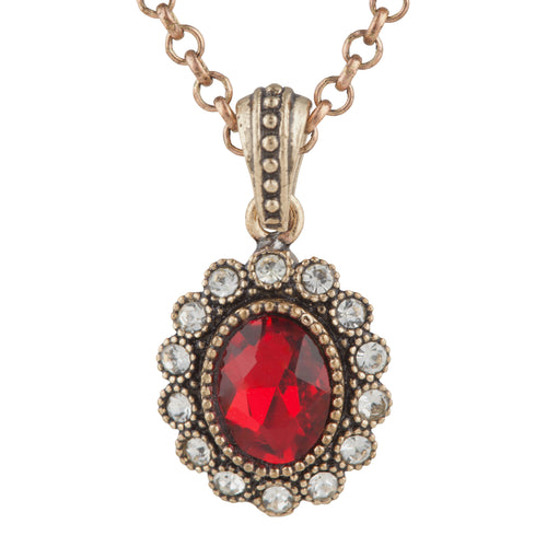 Jewelry pendant with a red gemstone and chain on a white background