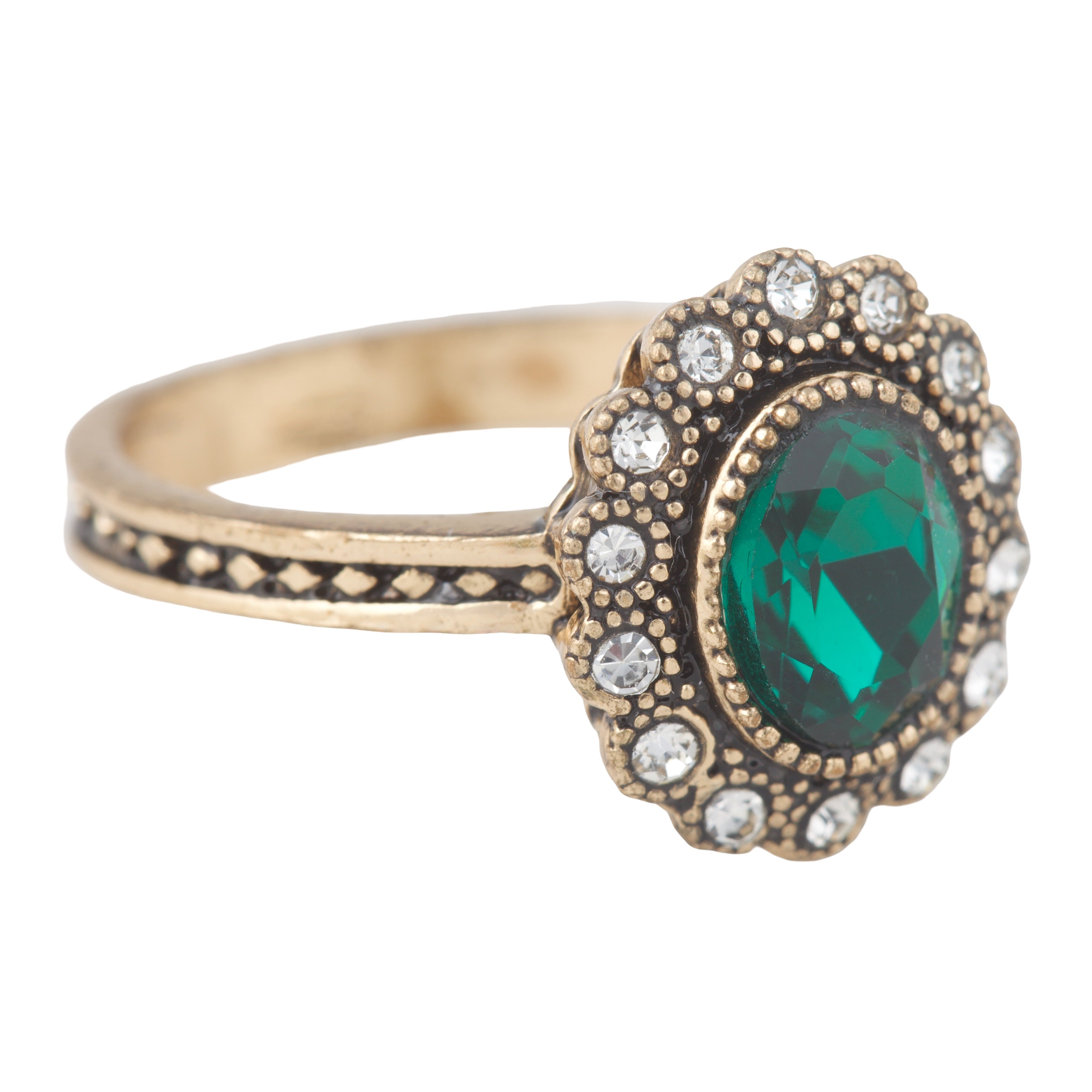 Gold ring with a green gemstone and diamond accents on a white background