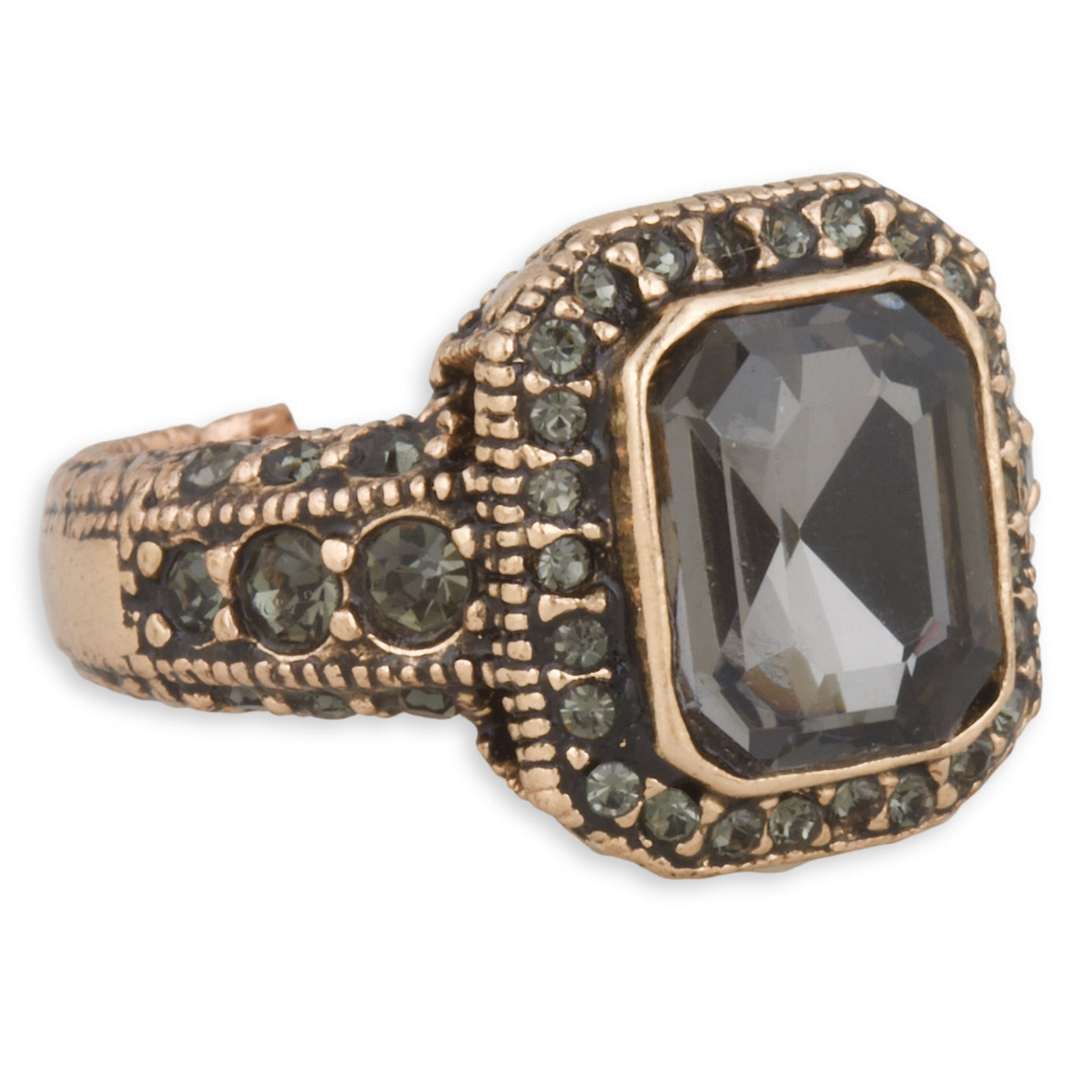 Decorative ring with a large black gemstone and smaller green stones on a white background