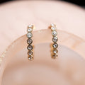 Pair of diamond earrings on a blurred background