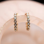 Pair of diamond earrings on a blurred background