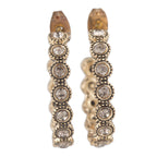 Pair of gold hoop earrings with embedded crystals on a white background