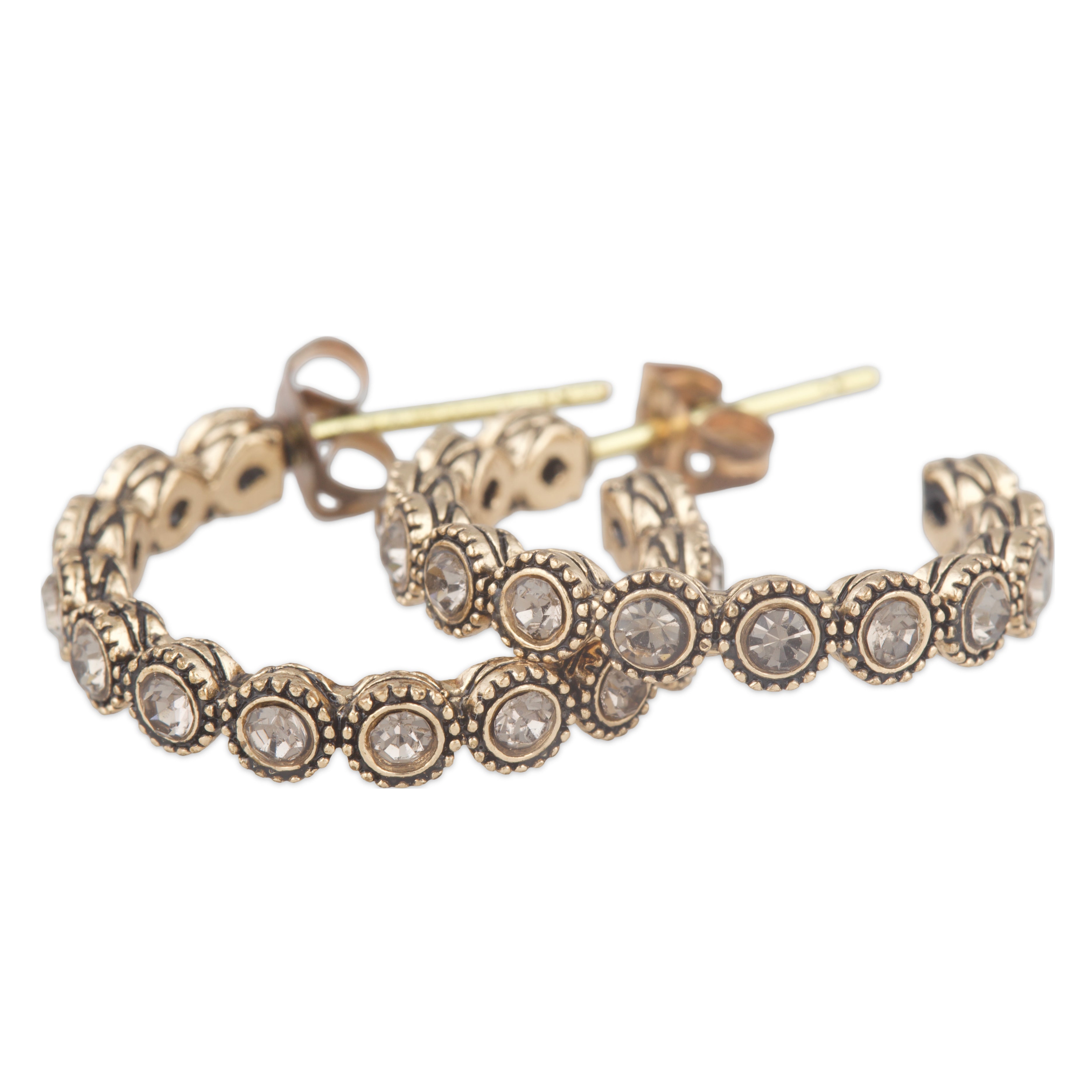 Gold hoop earrings with gemstones on a white background
