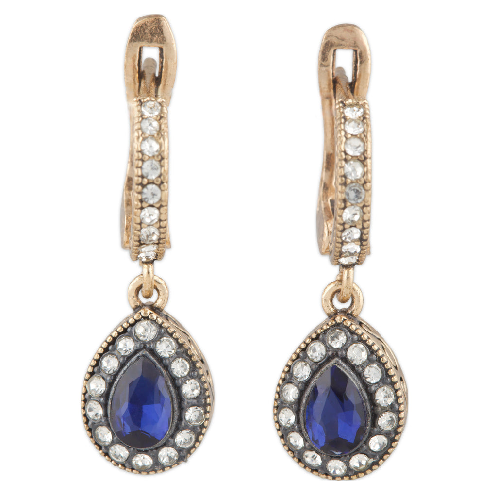 Pair of earrings with blue gemstones and gold accents on a white background