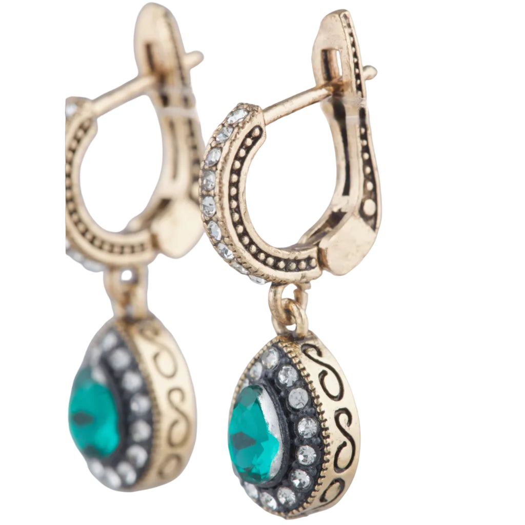 Gold hoop earrings with turquoise stones on a white background