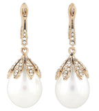 Pair of pearl earrings with gold and diamond accents on a white background