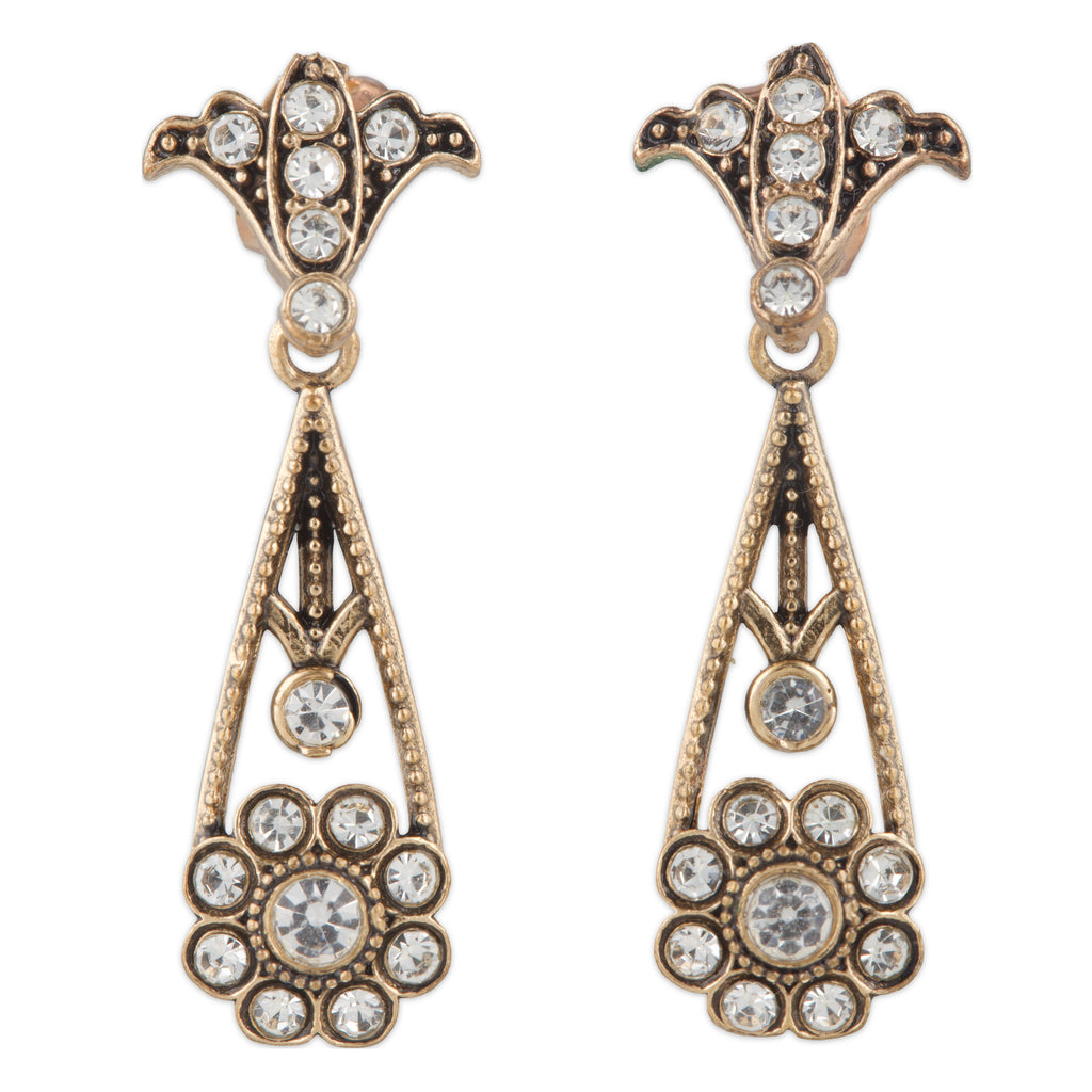 Pair of ornate earrings with crystal-like stones on a white background