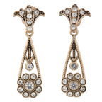 Pair of ornate earrings with crystal-like stones on a white background