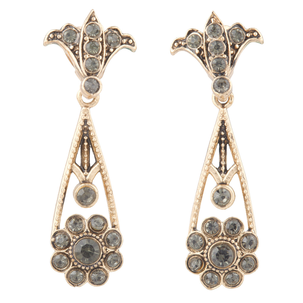 Pair of ornate earrings with gemstones on a white background
