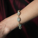 Close-up of a wrist wearing a diamond bracelet against a dark background