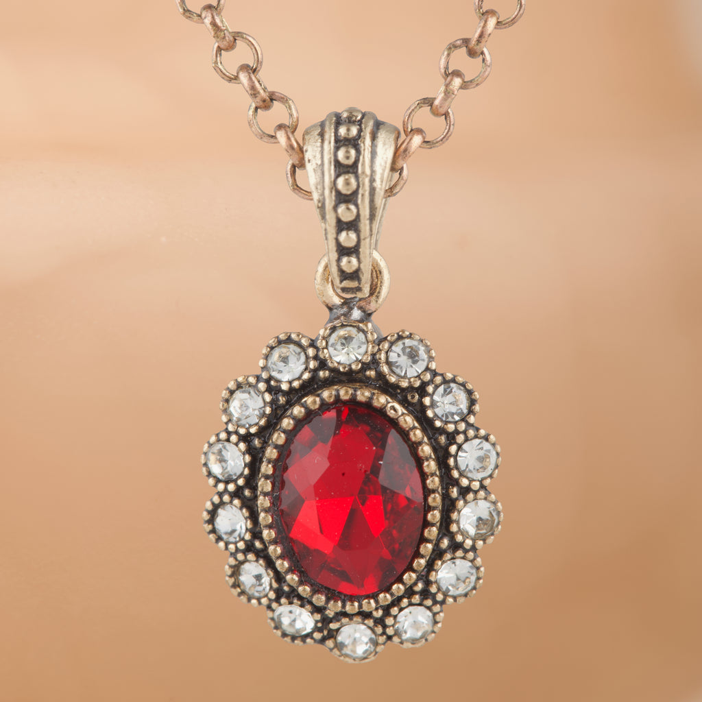 Necklace with a red gemstone pendant on a beige background