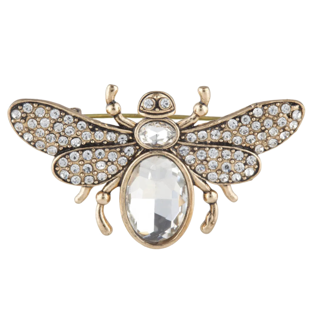 Gold bee-shaped brooch with crystal stones on a white background