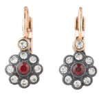 Pair of earrings with floral design and red gemstone on a white background