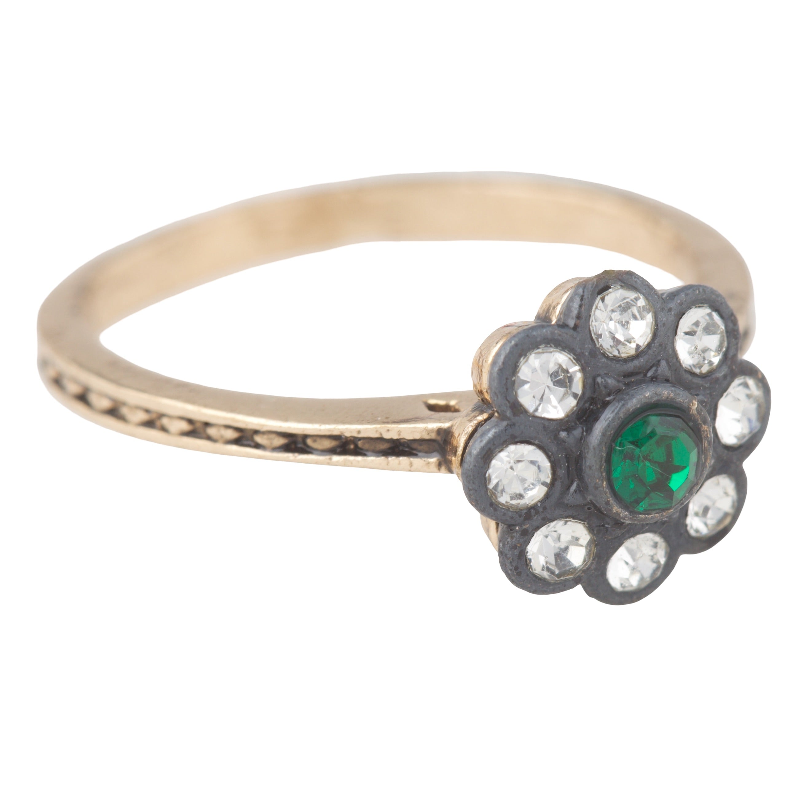 Gold ring with a floral design featuring green gemstone and clear stones on a white background