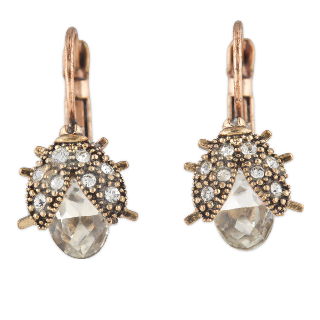 Pair of earrings with rose gold and clear gemstone design on a white background