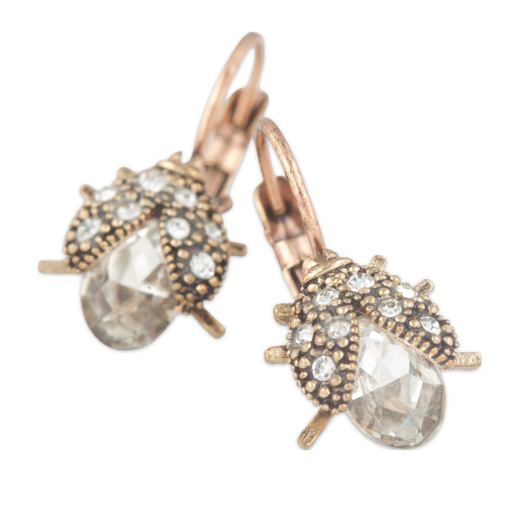 Pair of earrings with rose gold and bronze detailing on a white background