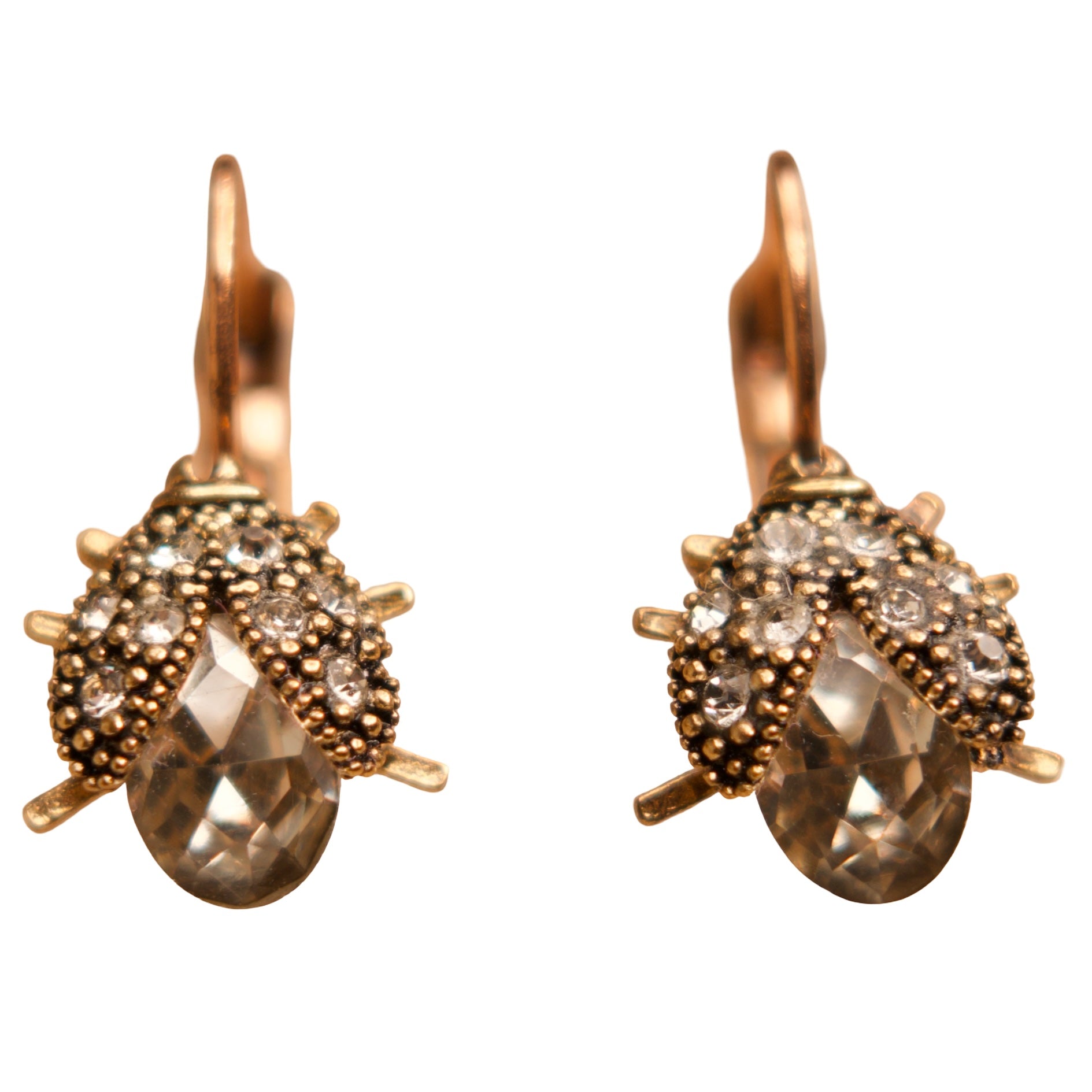 Pair of gold earrings with gemstones on a white background