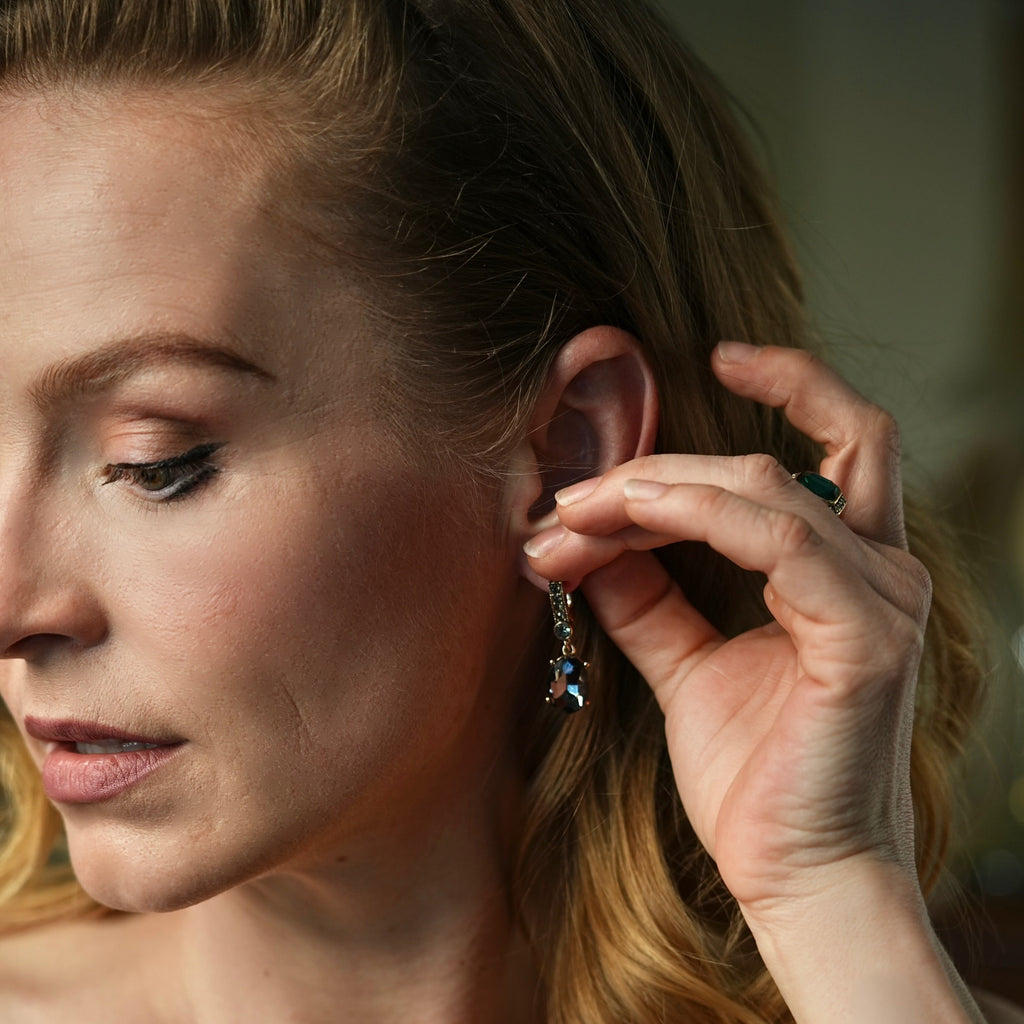 Woman adjusting an earring with a blurred background