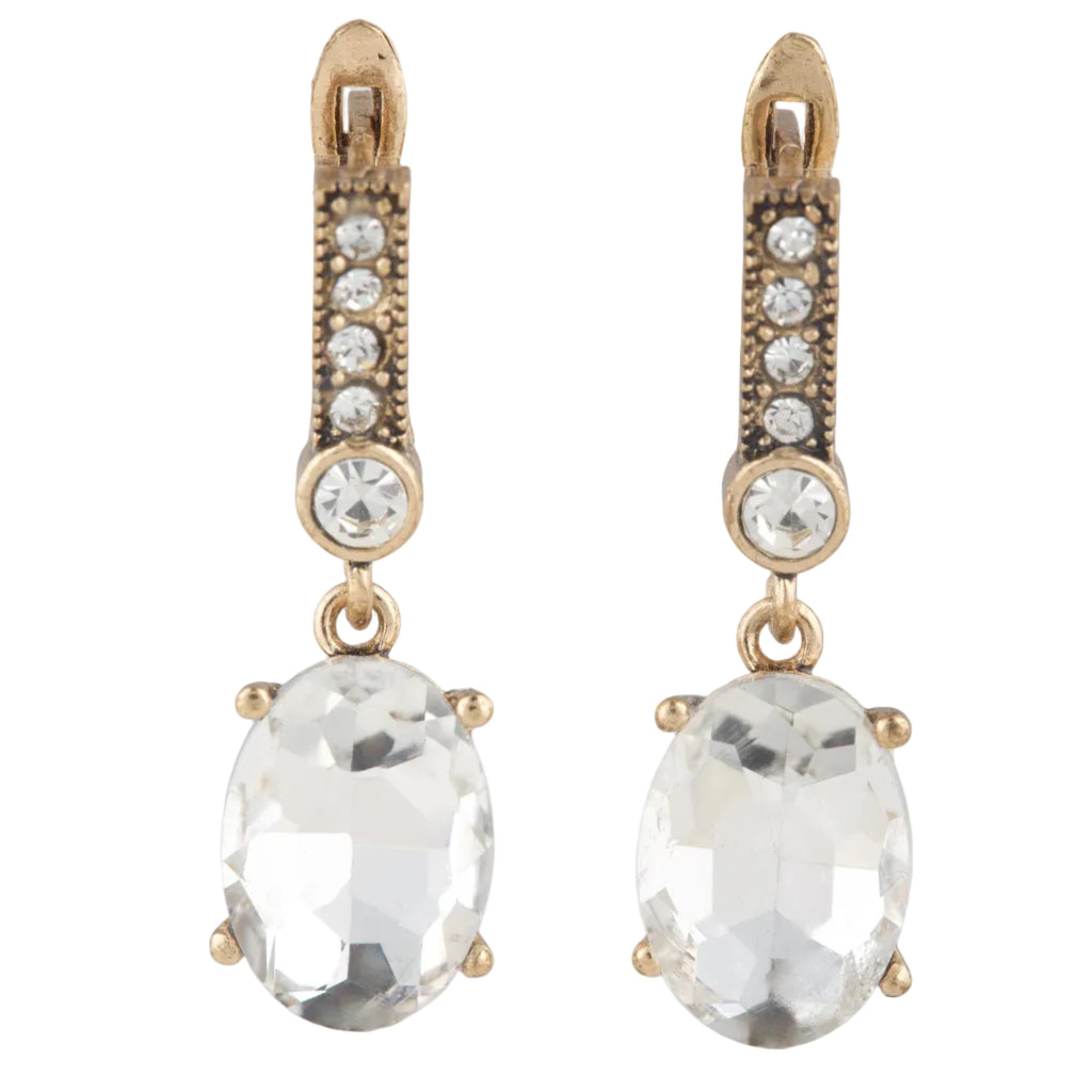 Pair of gold earrings with clear gemstones on a white background