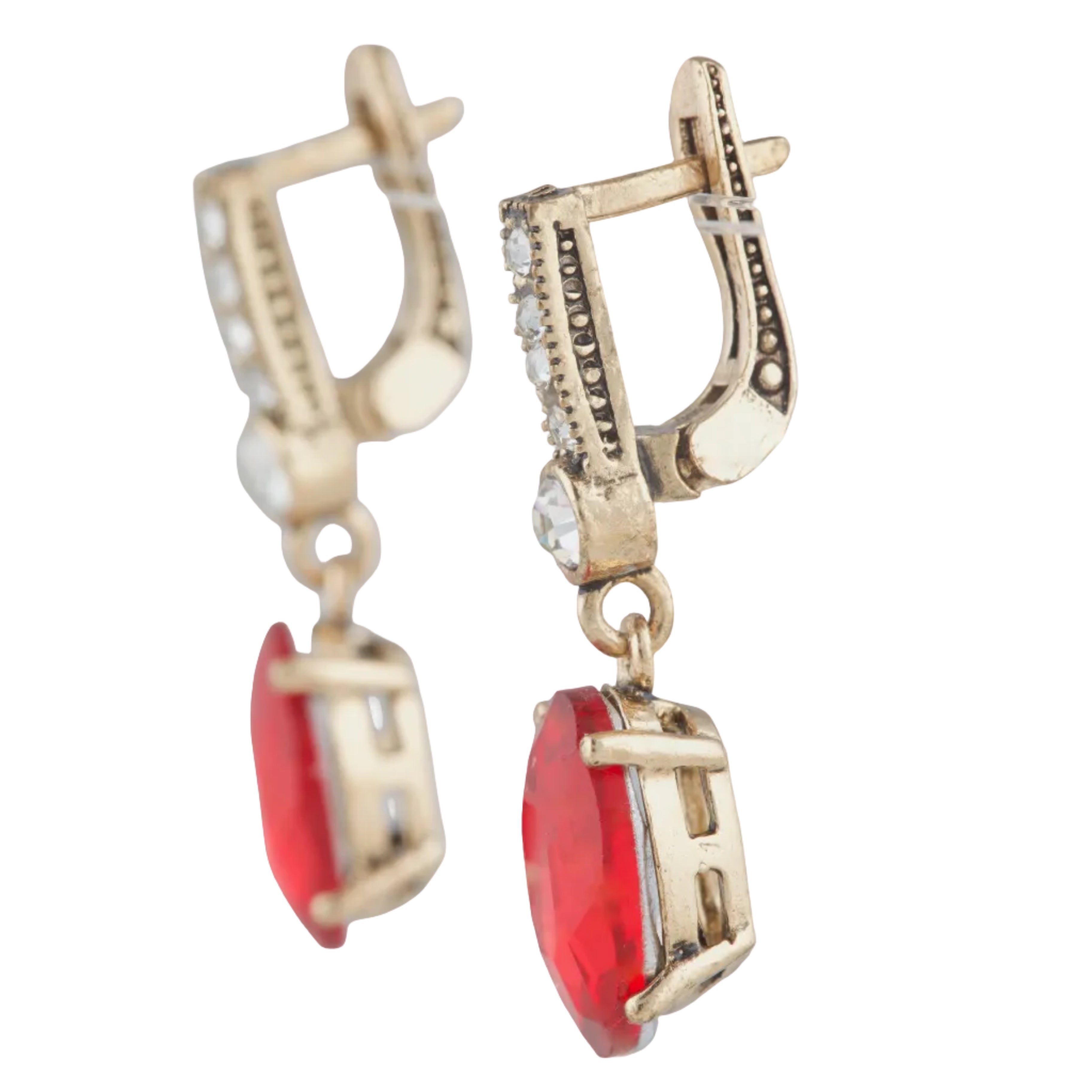 Gold earrings with red gemstones on a white background
