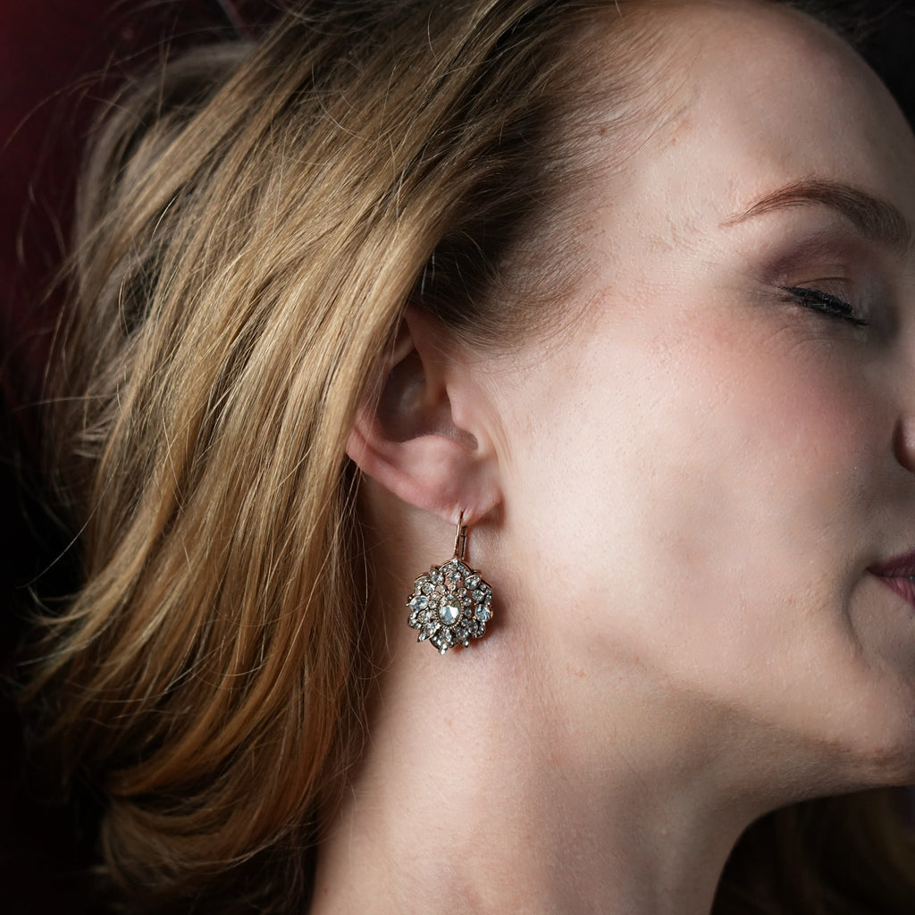 Close-up of a woman wearing a sparkling earring.