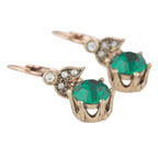 Gold earrings with green gemstones on a white background
