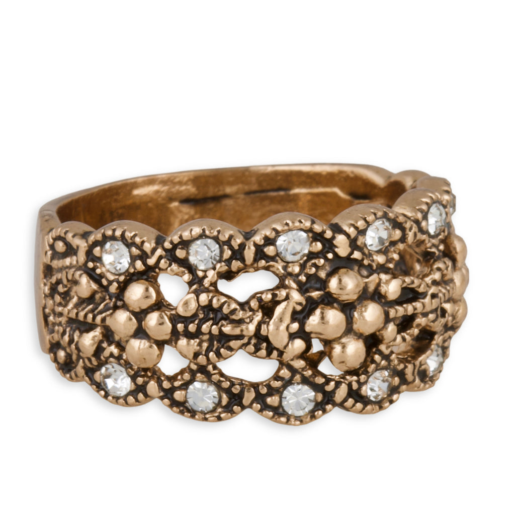 Gold ring with intricate design and embedded diamonds on a white background