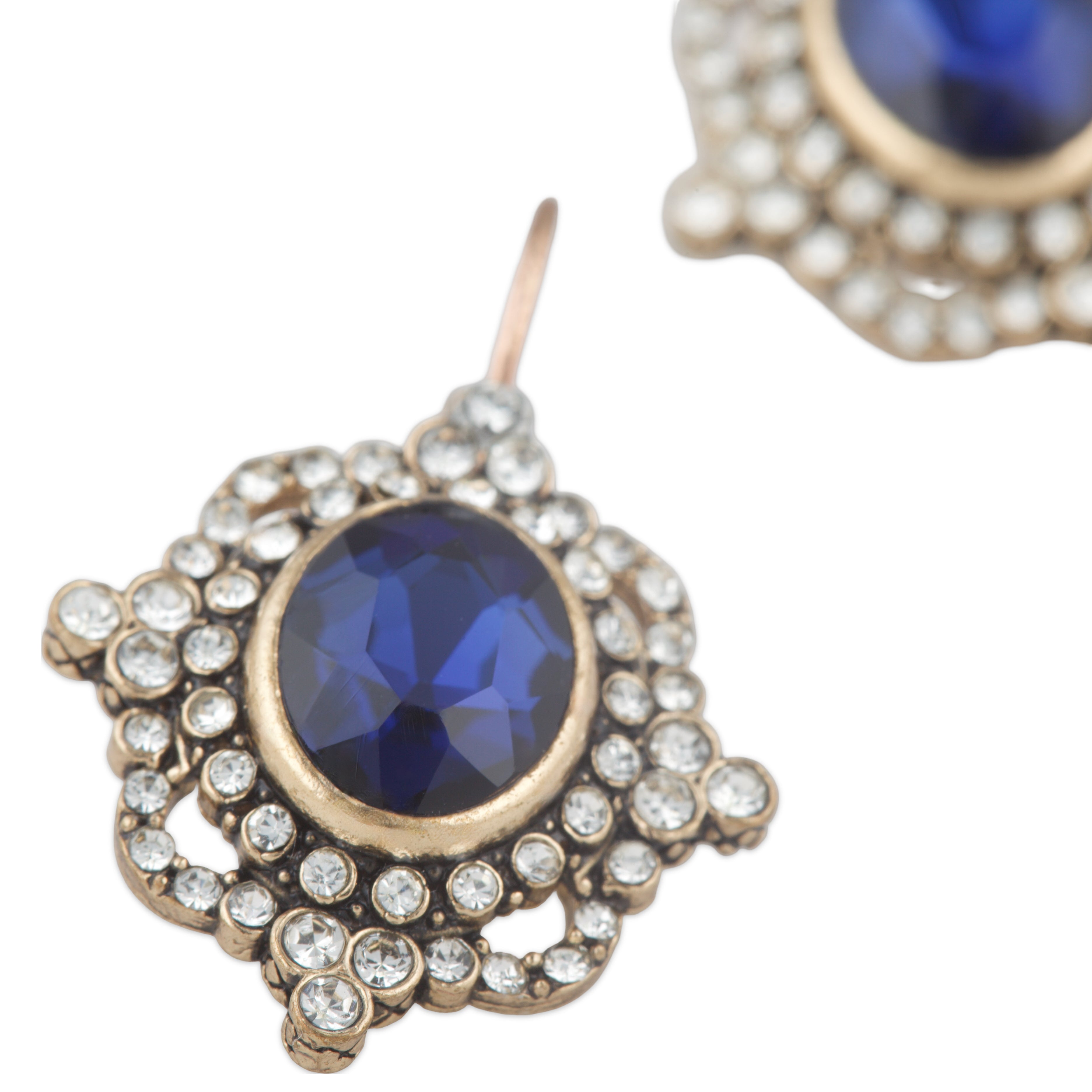 Earrings with blue gemstones and gold accents on a white background