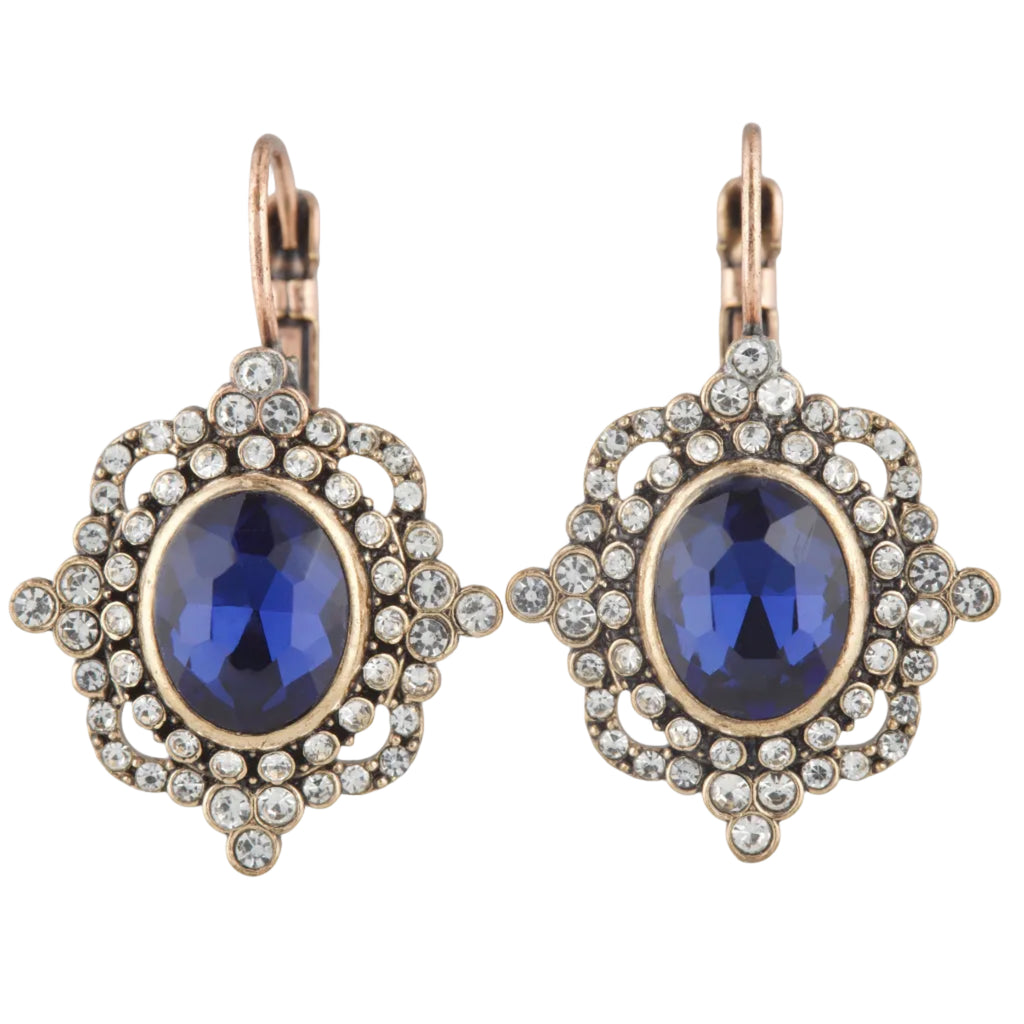 Pair of earrings with blue gemstones and gold accents on a white background