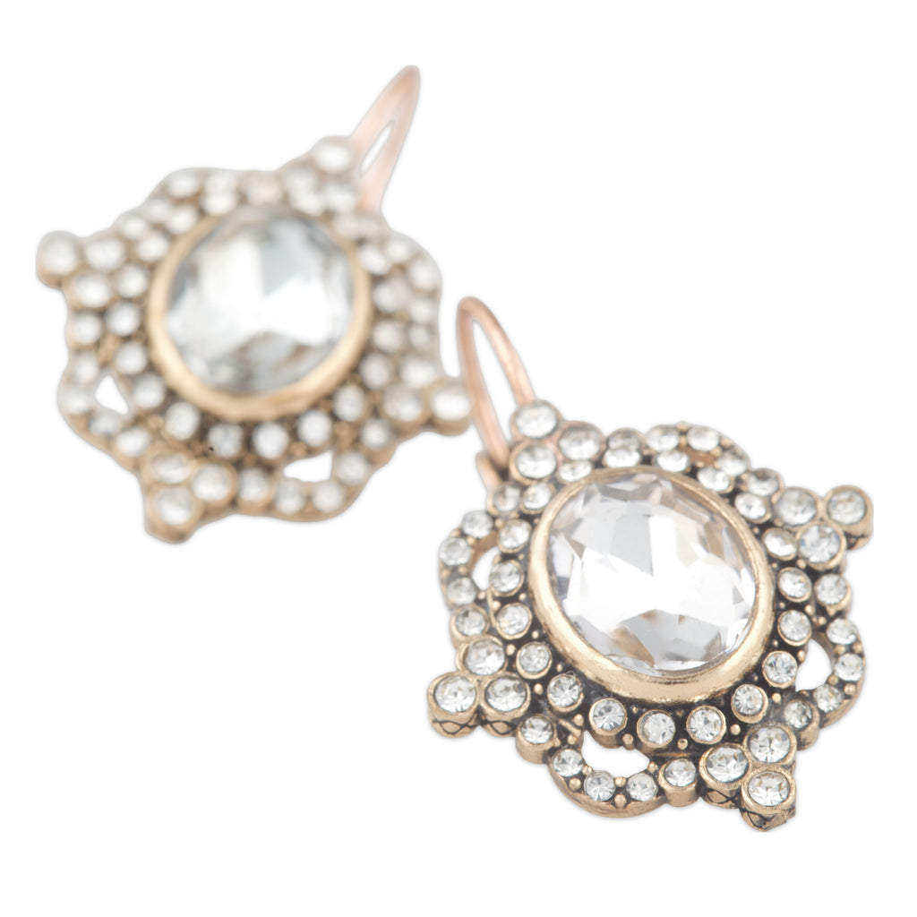 Gold and crystal earrings on a white background