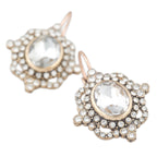 Gold and crystal earrings on a white background
