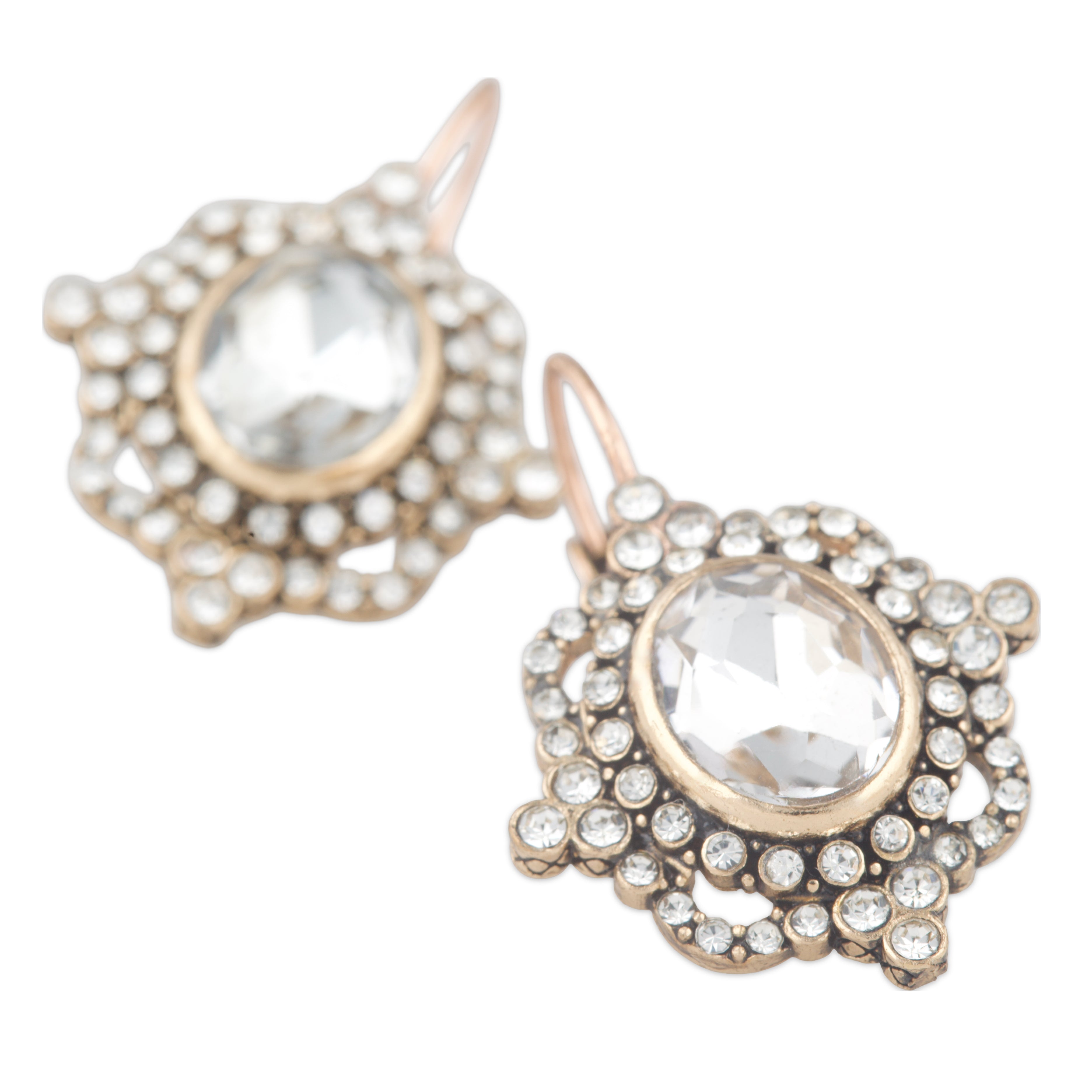 Gold and crystal earrings on a white background