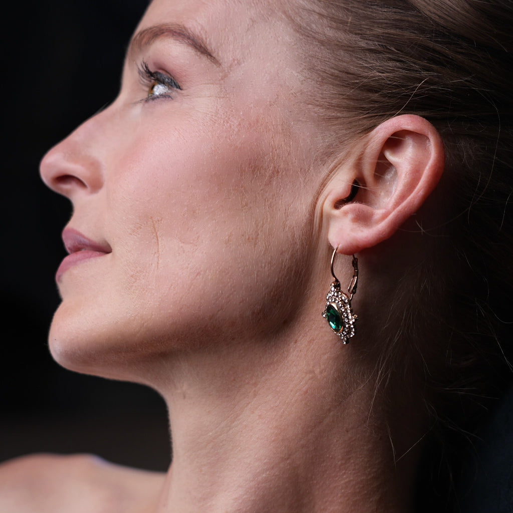 Close-up of a woman wearing an earring with a dark background