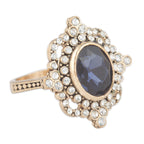 Elegant ring with a dark gemstone and gold accents on a white background
