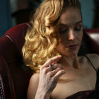 Woman holding a ring in a dimly lit room