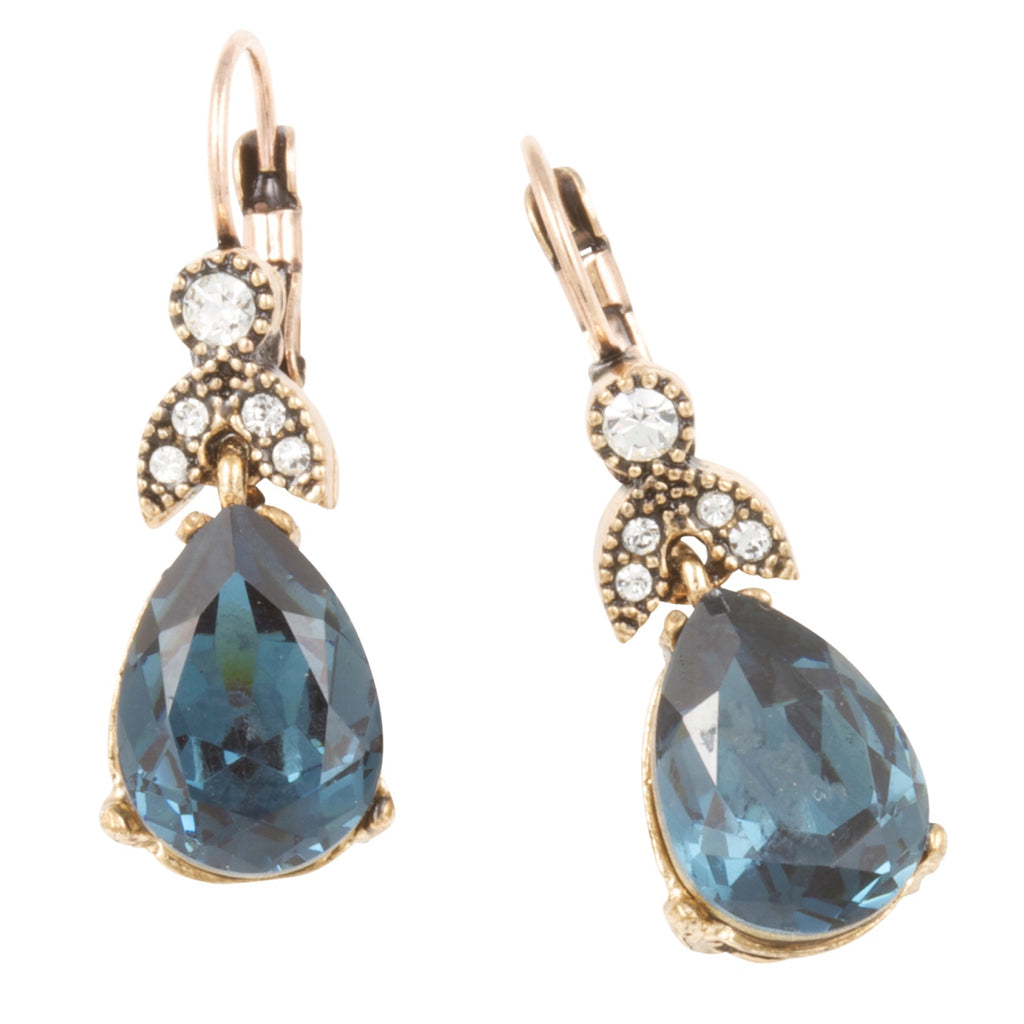 Pair of earrings with blue teardrop stones and gold accents on a white background
