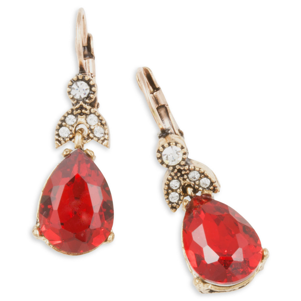 Pair of earrings with red teardrop-shaped gemstones and gold accents on a white background