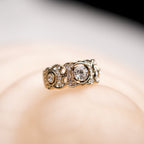 Gold ring with diamonds on a soft focus background