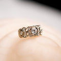 Gold ring with diamonds on a soft focus background
