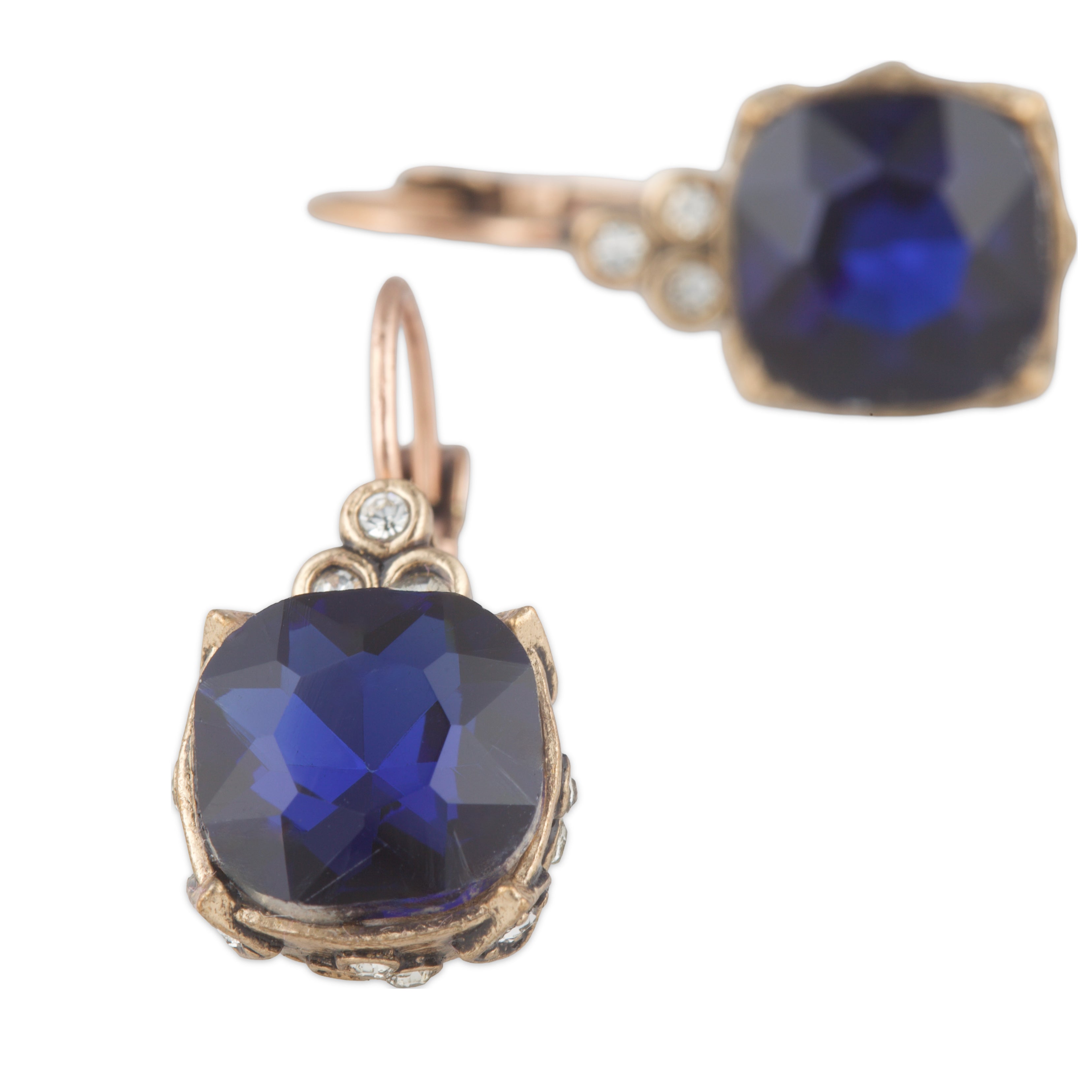 Pair of earrings with blue gemstones and gold accents on a white background