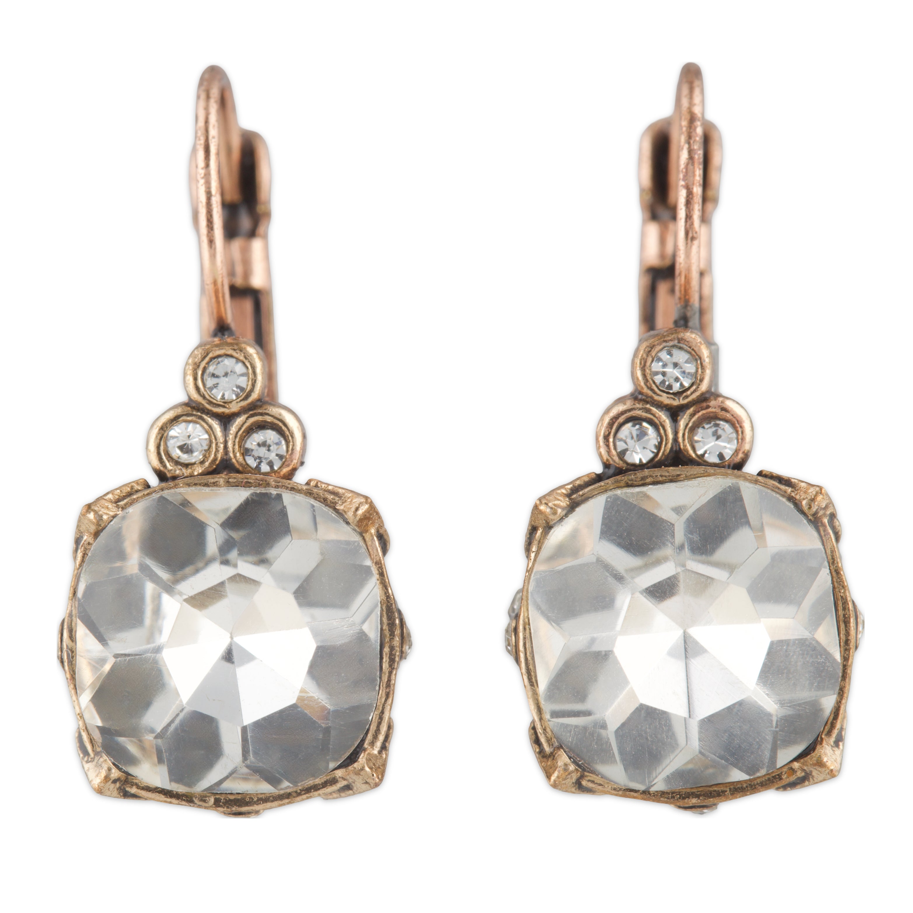 Pair of earrings with large crystal stones and rose gold accents on a white background